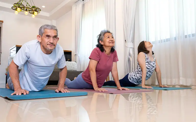 Elderly people practicing yoga for digestion